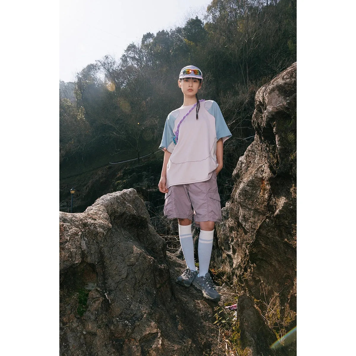 Man wearing a loose fit patchwork t-shirt in a solid colour with short raglan sleeves.
