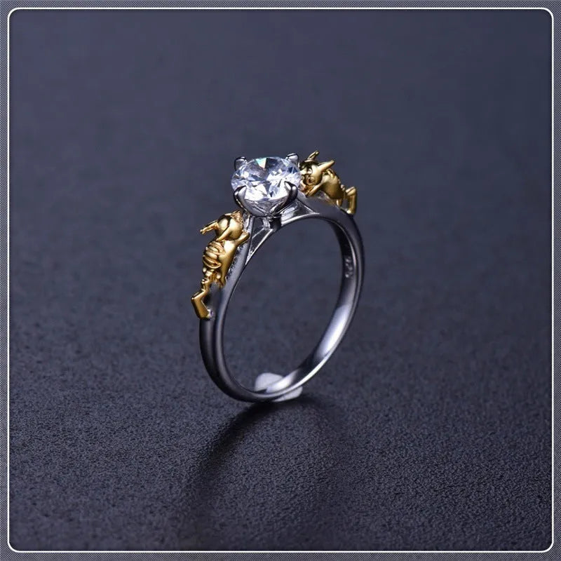Copper crown modelling cosplay ring in a black gold finish on a hand.