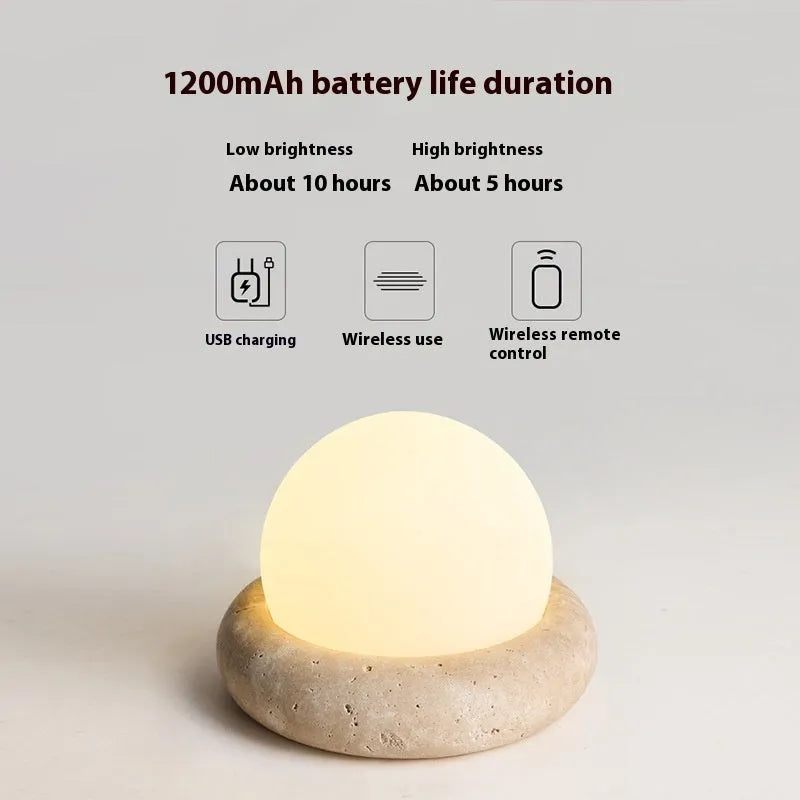 Cream modern bedside table lamp with remote control on wooden surface
