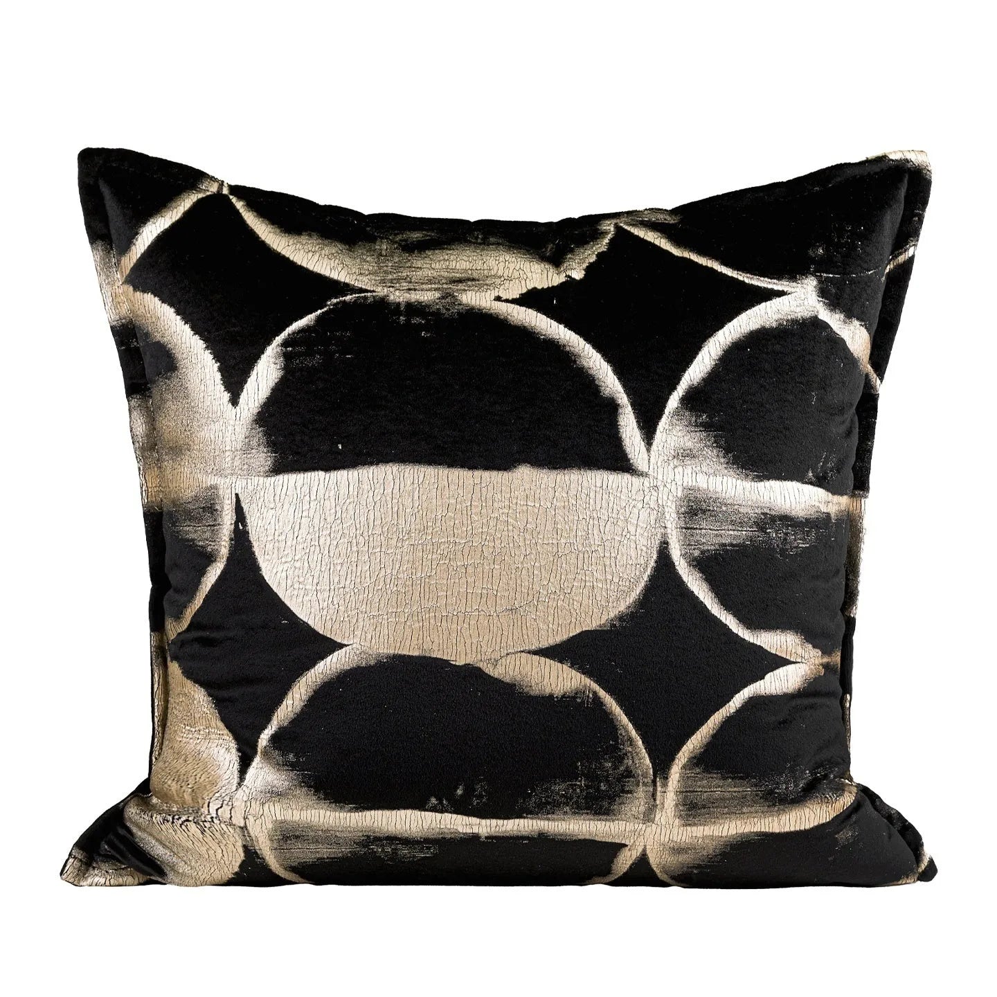 Black and gold abstract patterned flannel decorative pillow with removable cover on a grey sofa.