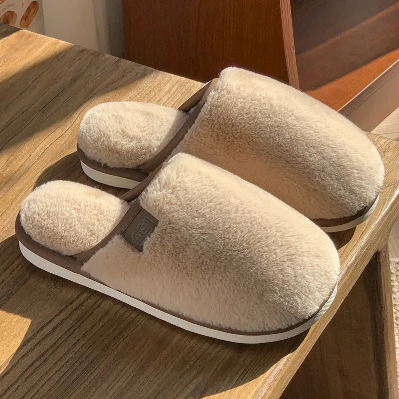 Solid colour PVC plush slippers with non-slip sole and car stitching detail on a wooden floor.