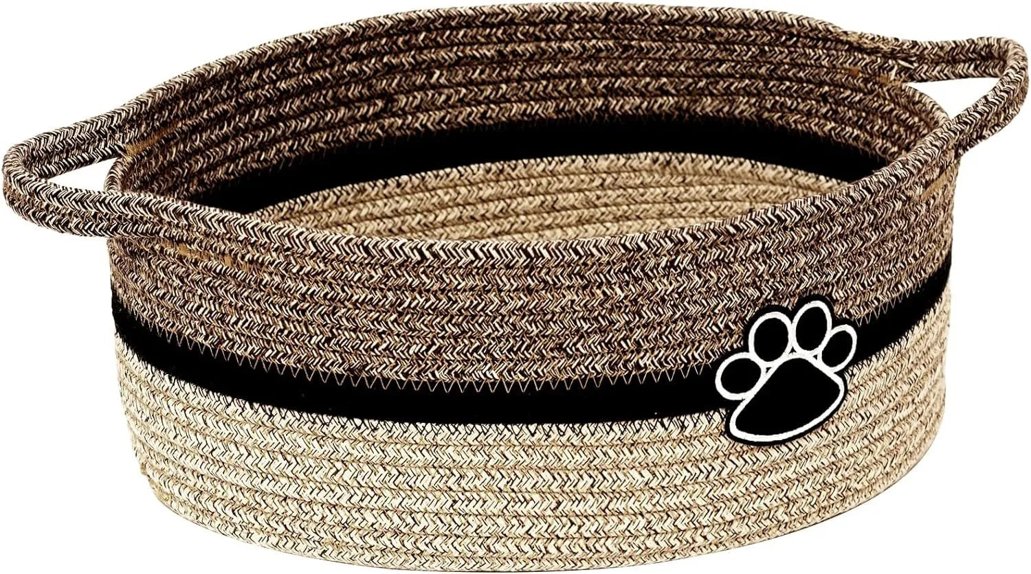 Small light beige handmade cotton rope storage basket with wooden handle on a table.