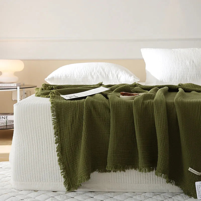 Four-layer gauze cotton blanket with tassel detailing in avocado green colour