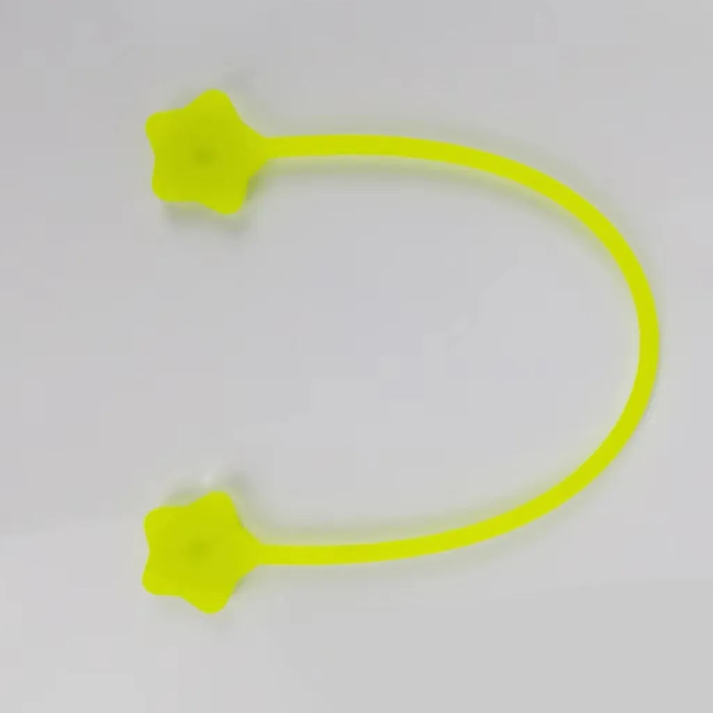 Purple silicone star-shaped cable winder with magnet, holding a coiled white USB cable.