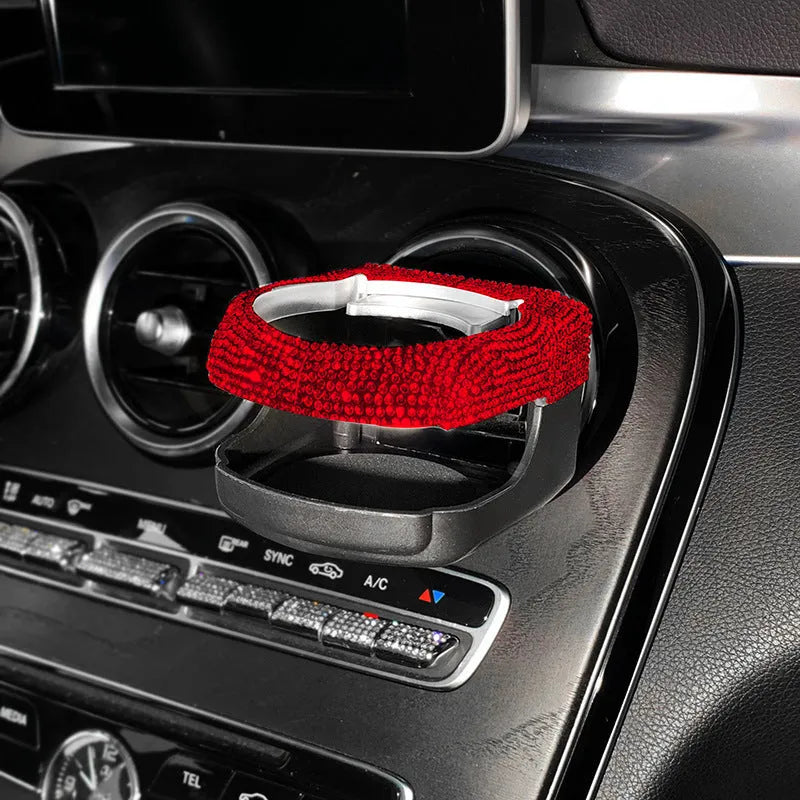 White diamond decorated ABS plastic car vent cup holder mounted in a car air vent.