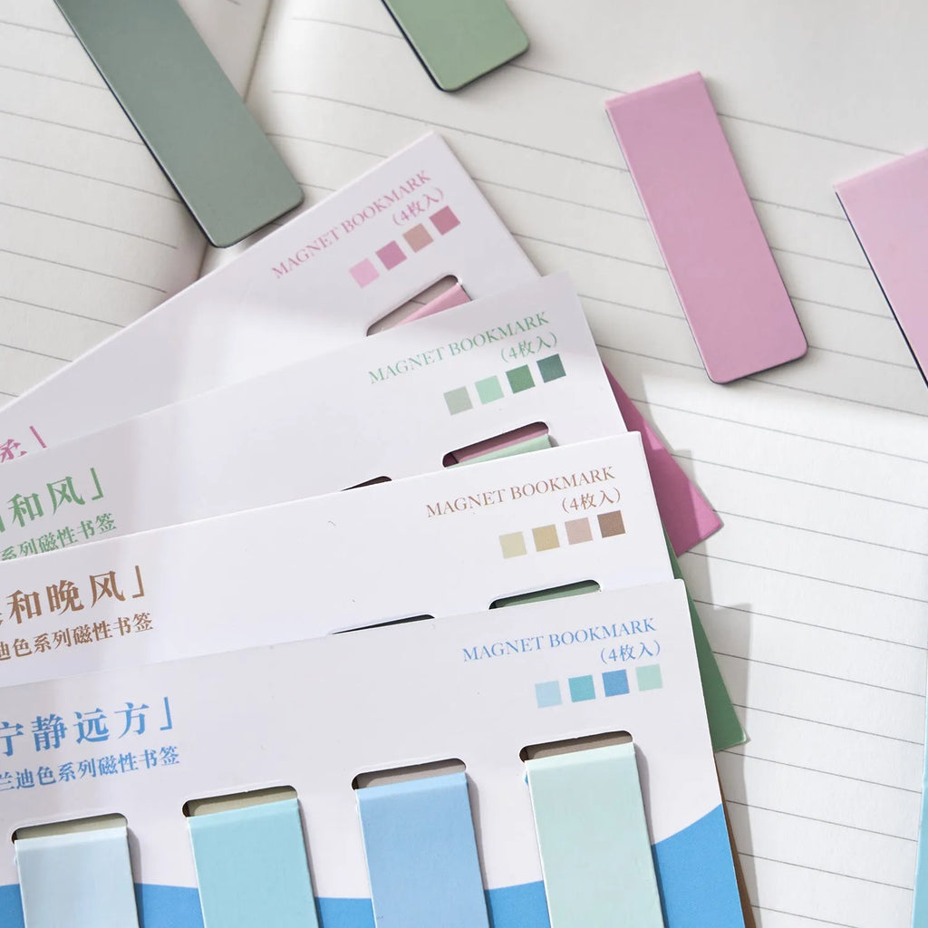 Set of four Morandi Series colour block magnetic bookmarks in pastel shades on a book page.