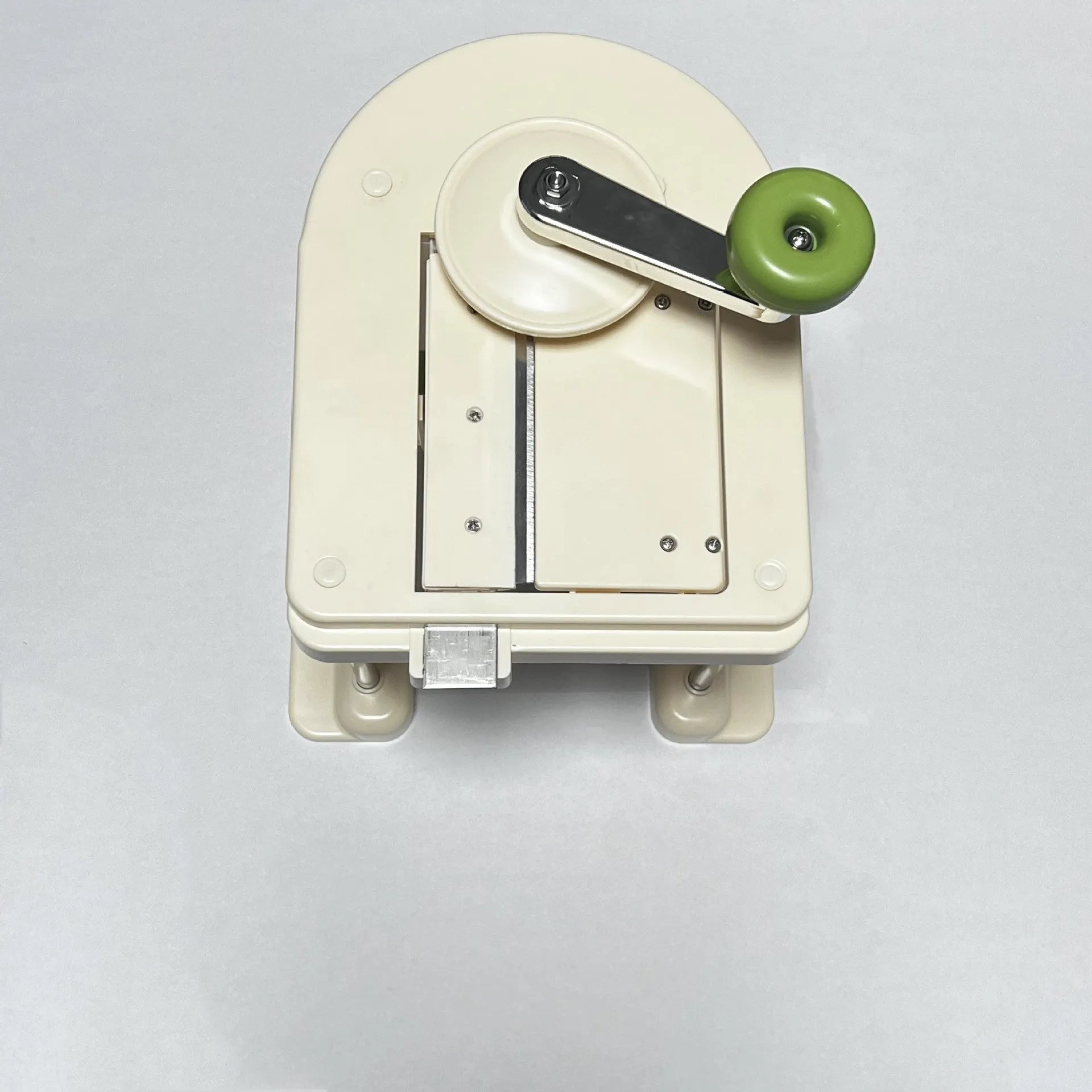 Beige stainless steel multifunctional vegetable slicer chopper and grater kitchen tool.