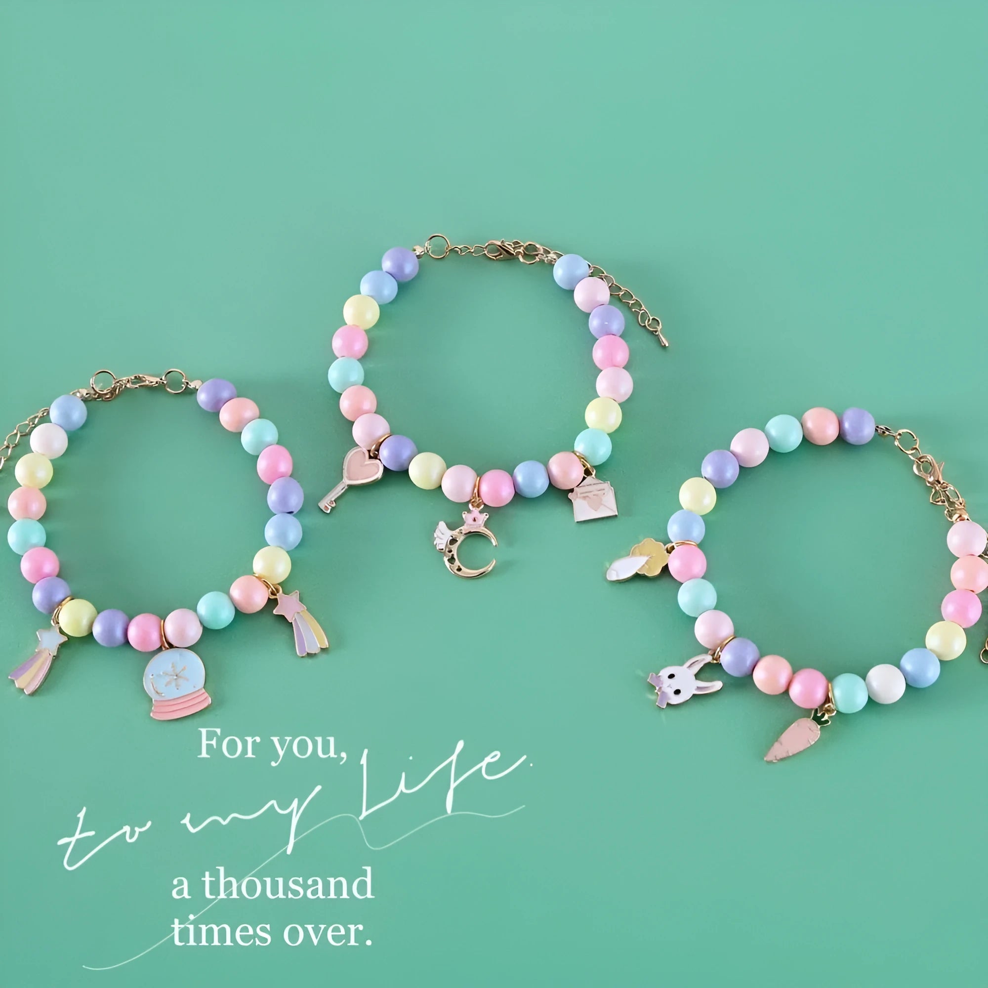 Macaron-coloured resin pet collar and bracelet set for birthday photoshoots on a neutral background.