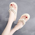 Women's beige high-heeled flip-flops with a cotton cloth upper on a white background.