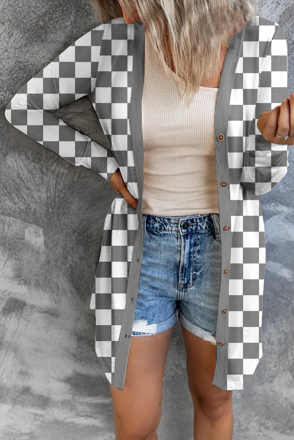 Long grey plaid knitted cardigan coat on a model, showing loose fit and regular sleeves.