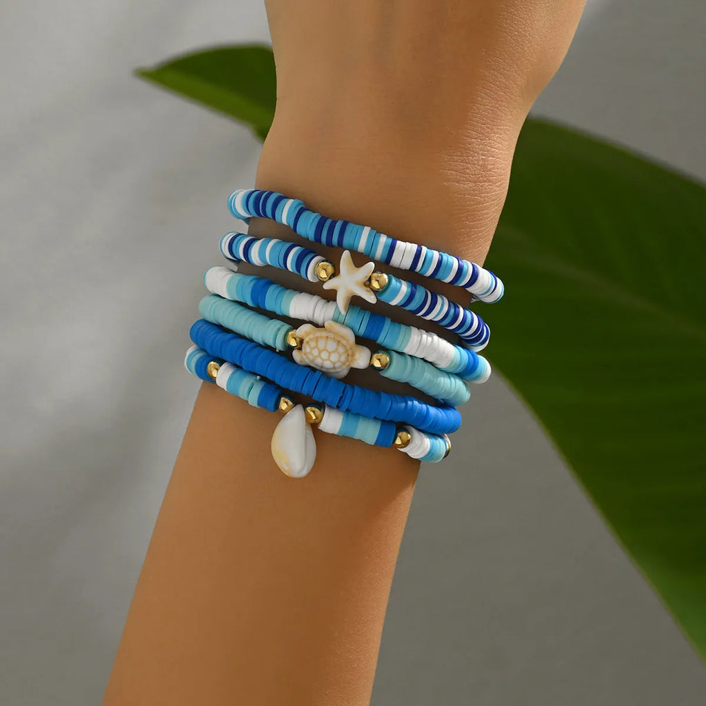 Bohemian blue polymer clay handmade shell bracelet suit with six geometric bracelets on display