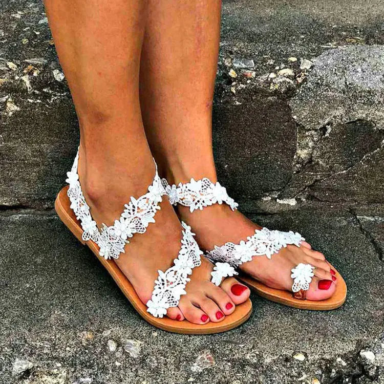 White plus size women's flat sandals with rhinestone flower decoration and round toe.