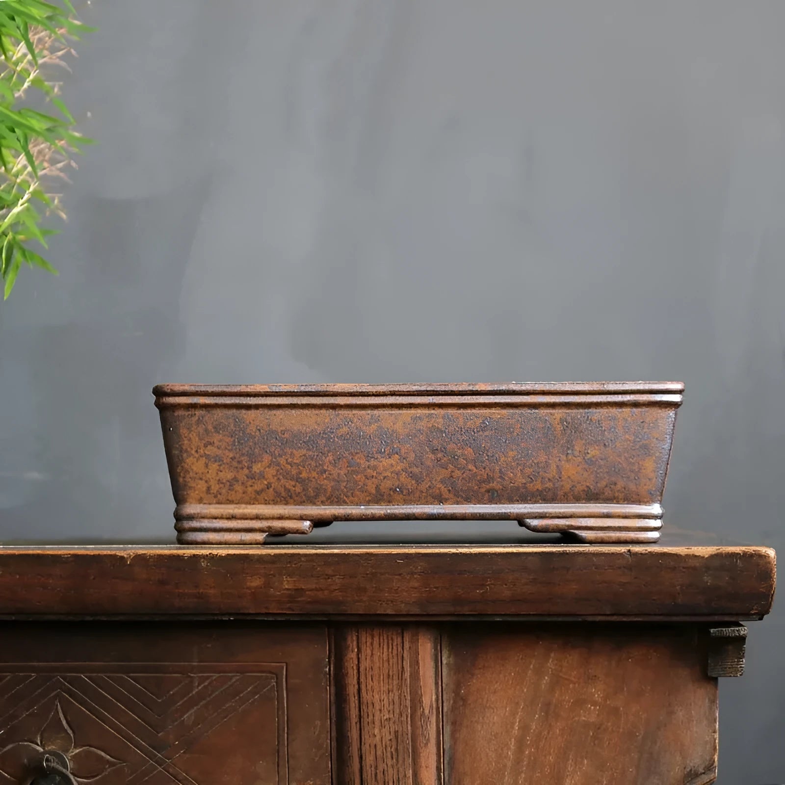 Purple sand rectangular bonsai planter with five-line basin design on wooden surface