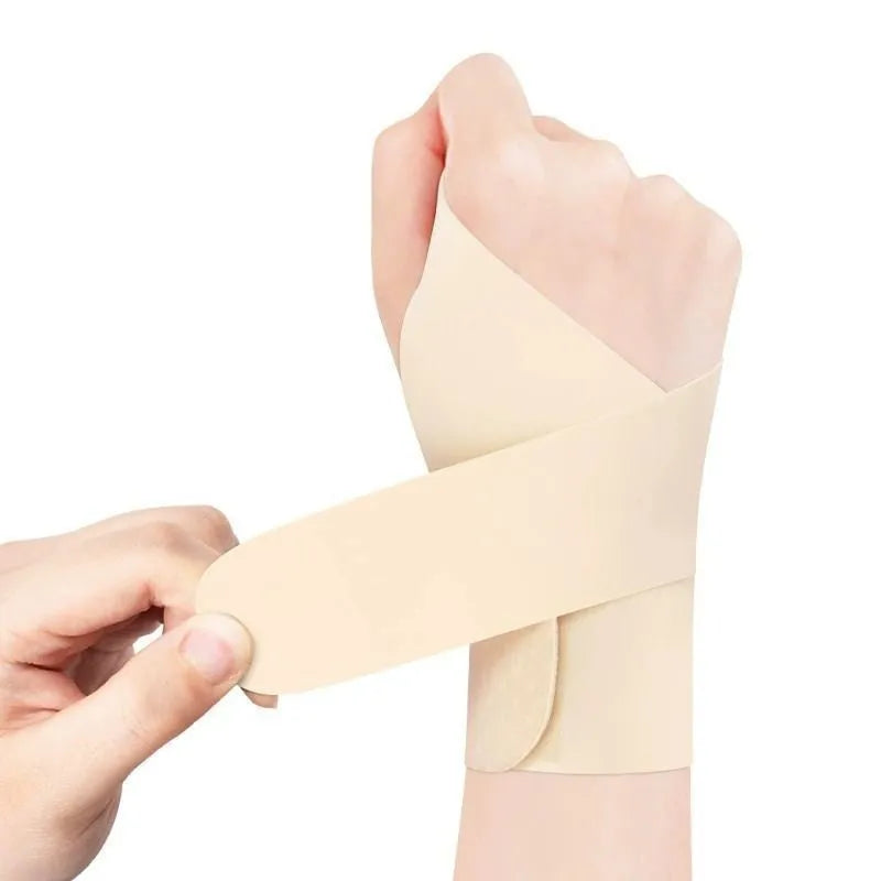 Adjustable black athletic wristguard worn on a wrist, suitable for sports like badminton and tennis.