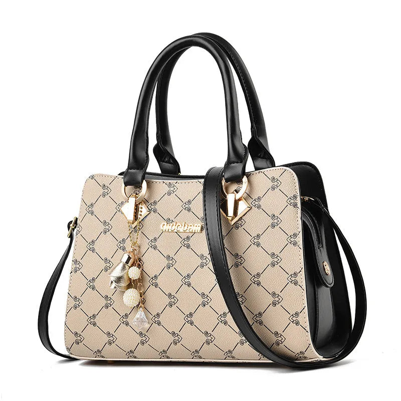 Women's geometric print PU leather messenger bag with internal organisers and zip closure.