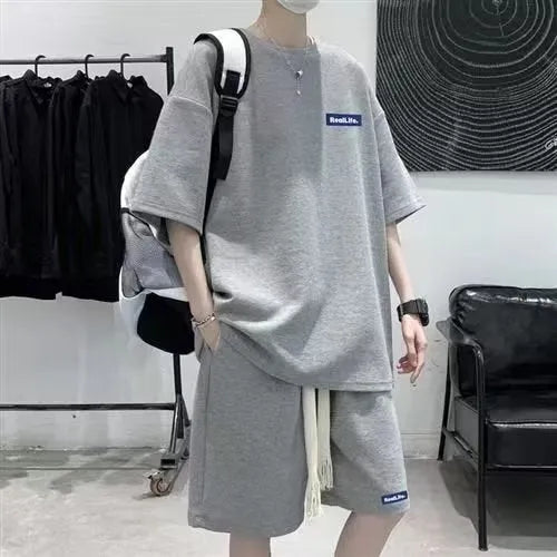 Waffle leisure sports suit consisting of short sleeve top and matching shorts in polyester cotton fabric