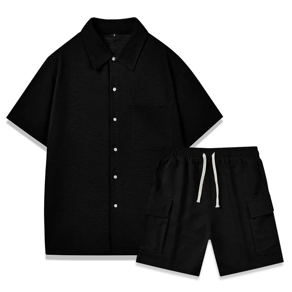 Plain grey polyester two-piece set with short sleeve top and elastic waist shorts laid flat.
