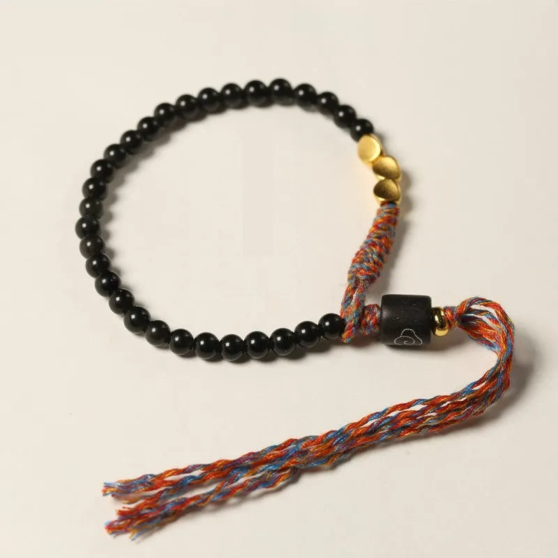 Hand-woven obsidian carrying strap bracelet showing braided detail and adjustable 15.5-16cm length