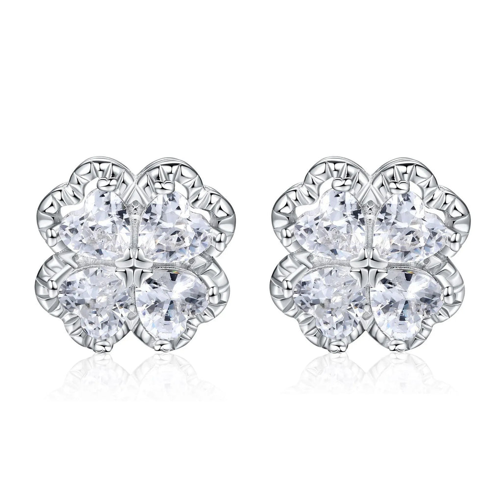 Close-up of women's 925 silver earrings with a four-leaf clover and heart design, inlaid with zircon stones in white gold colour.