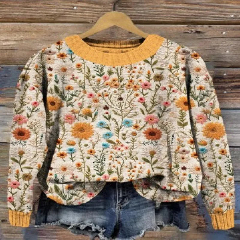 Women's lilac floral printed round neck sweater on a hanger showing the knitted texture.