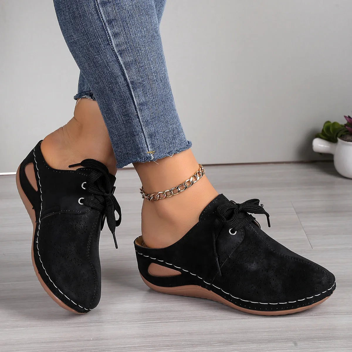 Women's black suede lace-up wedge slippers with a baotou toe and hollow out heel on a rubber sole.