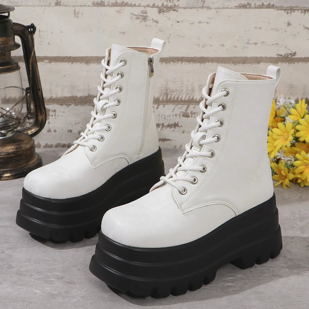 Women's black retro platform boots with patchwork round toe and side zip.