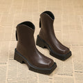 Black platform Martin ankle boots for women with a square toe and back zipper.