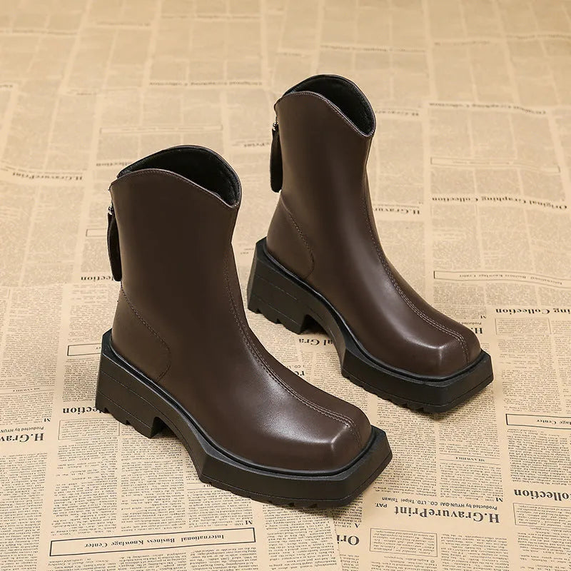 Black platform Martin ankle boots for women with a square toe and back zipper.