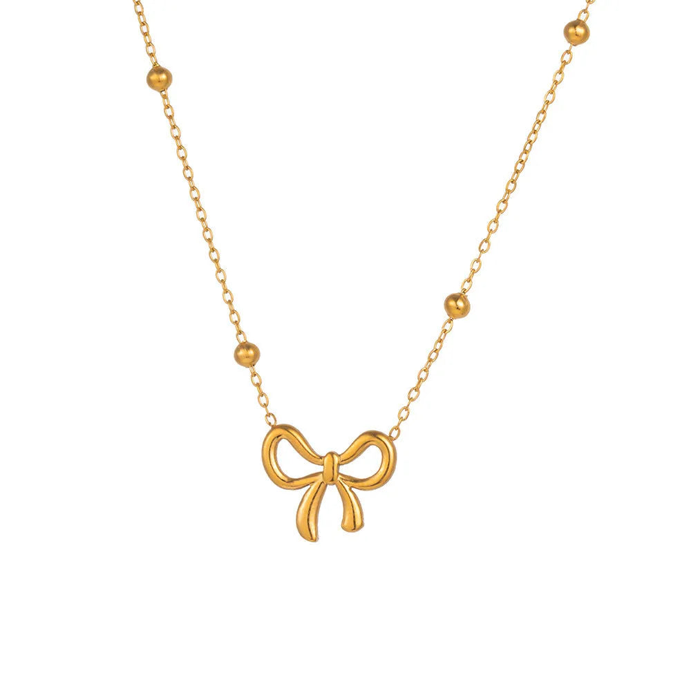 Gold electroplated titanium steel women's necklace with bow pendant and adjustable cross chain