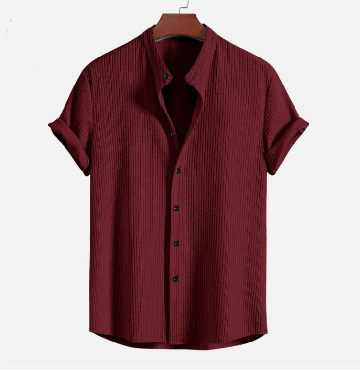 Men's loose fit short sleeve polyester summer shirt on a hanger, shown in a light blue colour.