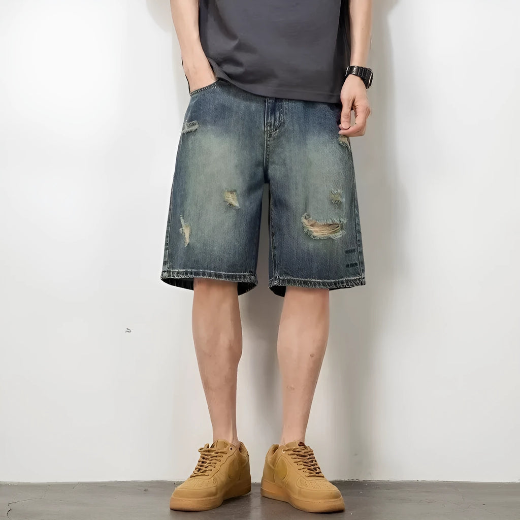 Blue distressed retro denim shorts for men on a white background