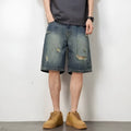 Blue distressed retro denim shorts for men on a white background