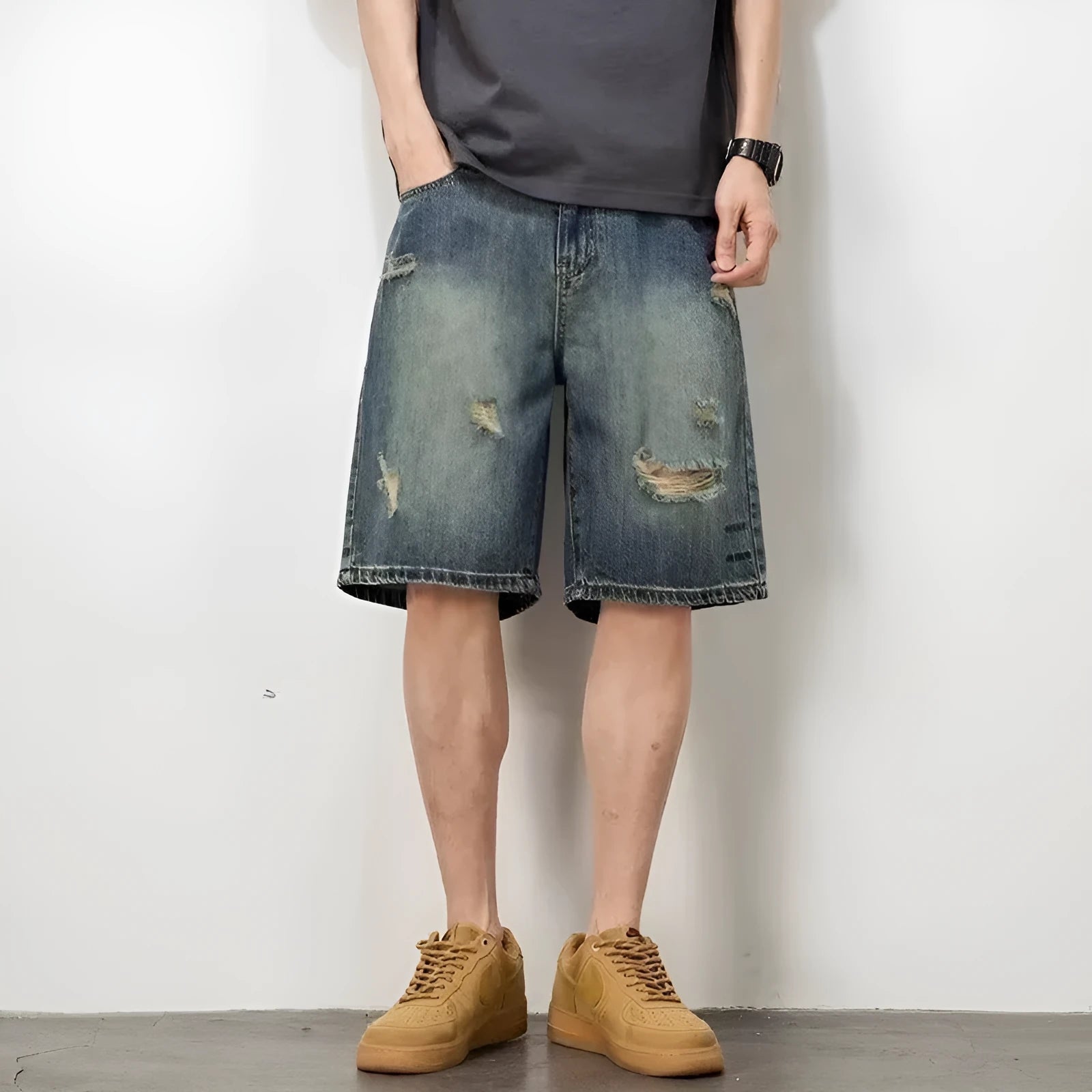 Blue distressed retro denim shorts for men on a white background