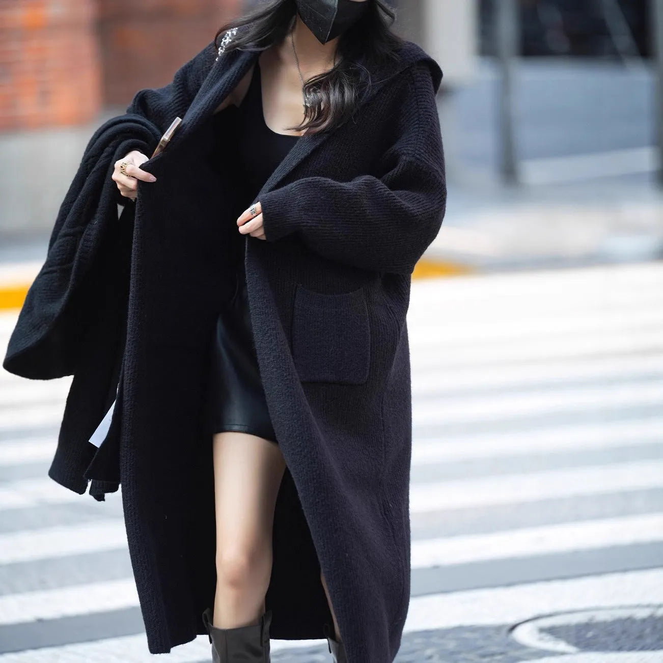 Long grey knitted hooded cardigan trench coat on a hanger showing its 80cm length and thick texture.