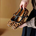 Women's black square toe stiletto heel ankle-strap shoes with horse hair upper.