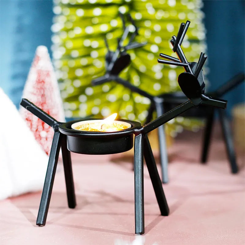 Black iron Christmas candlestick holder with detailed elk and deer design