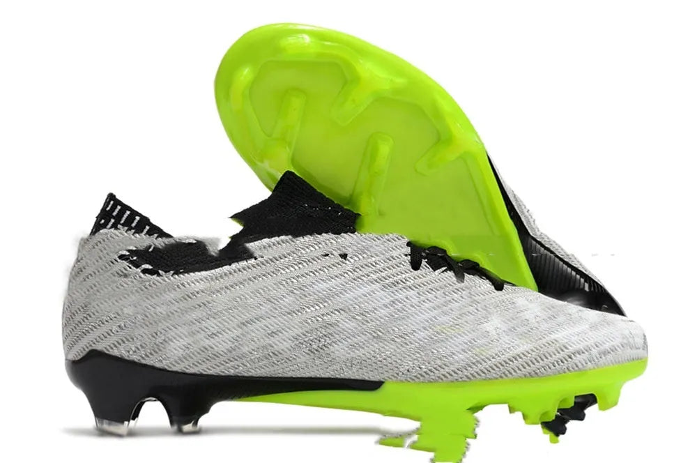 Men's low-top football shoes with knitted upper, lace-up front, and rubber sole with FG studs.