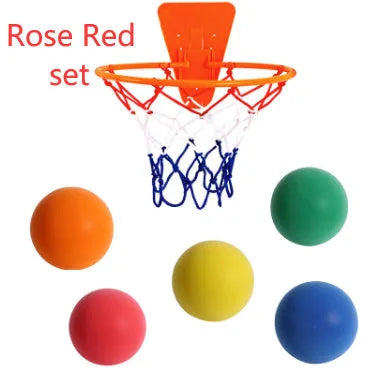 Silent high density foam sports ball in assorted bright colours next to a basketball frame.