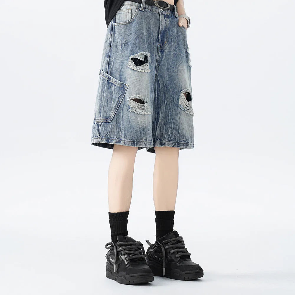 Loose fit ripped denim shorts in black and blue washes on a size chart