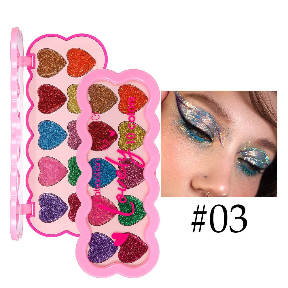 Pearlescent heart-shaped ten-colour sequin eyeshadow palette open, showing pink, blue, black, and coral shades.