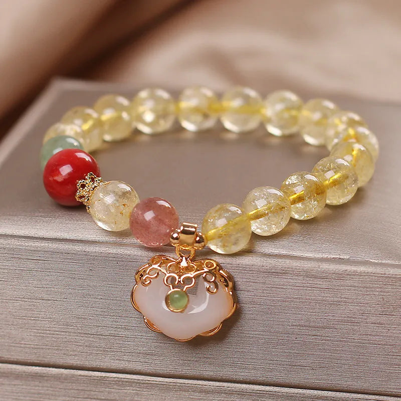 Women's yellow hair crystal jade Ruyi pendant on an alloy bracelet.