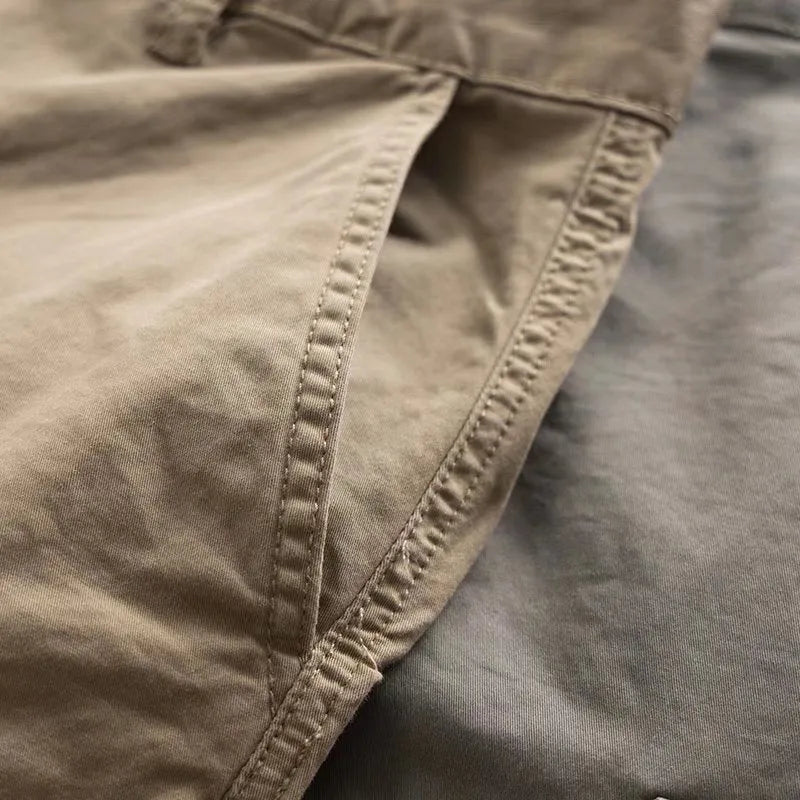 Man wearing khaki coloured multi-pocket cotton cropped work trousers.