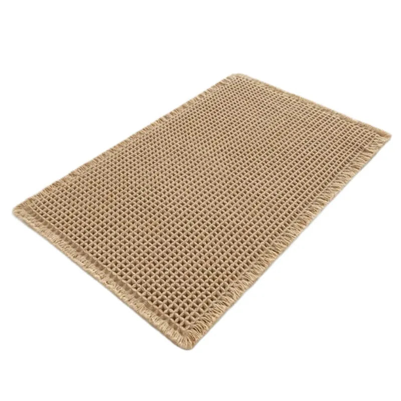 Square checkered-pattern non-slip bathroom carpet in a neutral colour on tiled floor.