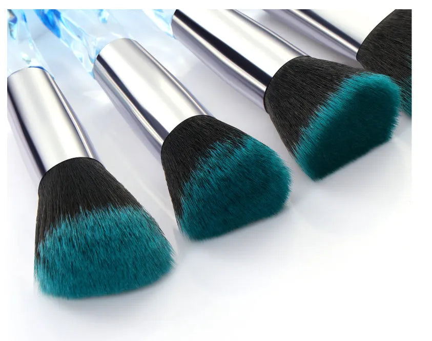 Ten crystal-handled foundation brushes with artificial fibre bristles in black, blue, red, and yellow.