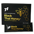 Glass jar of dark T1 Black Thai forest honey showing distinctive colour