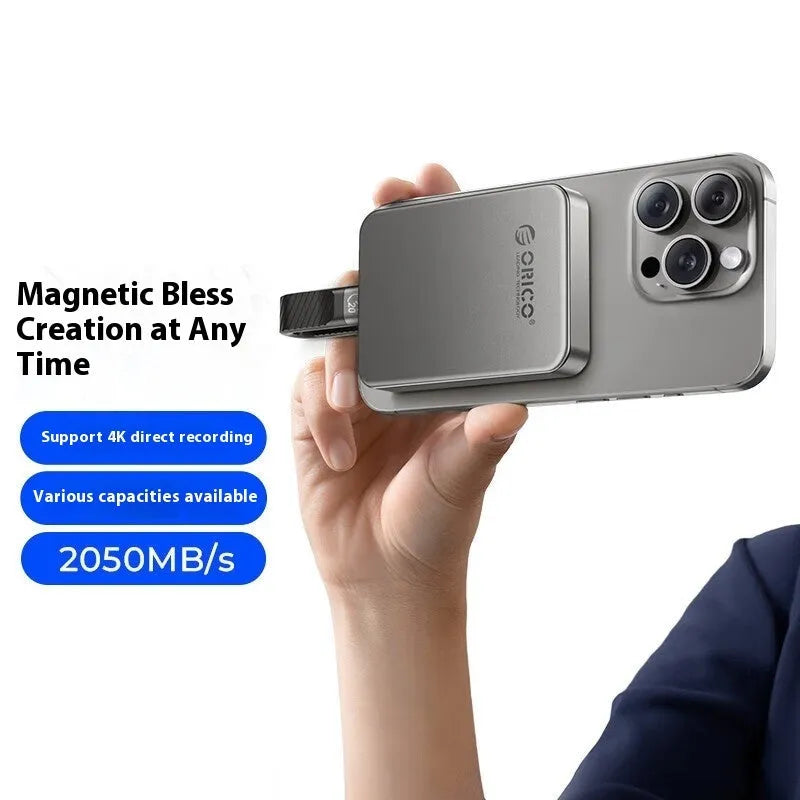 Grey magnetic mobile solid state drive with USB-C cable and magnetic suction ring.