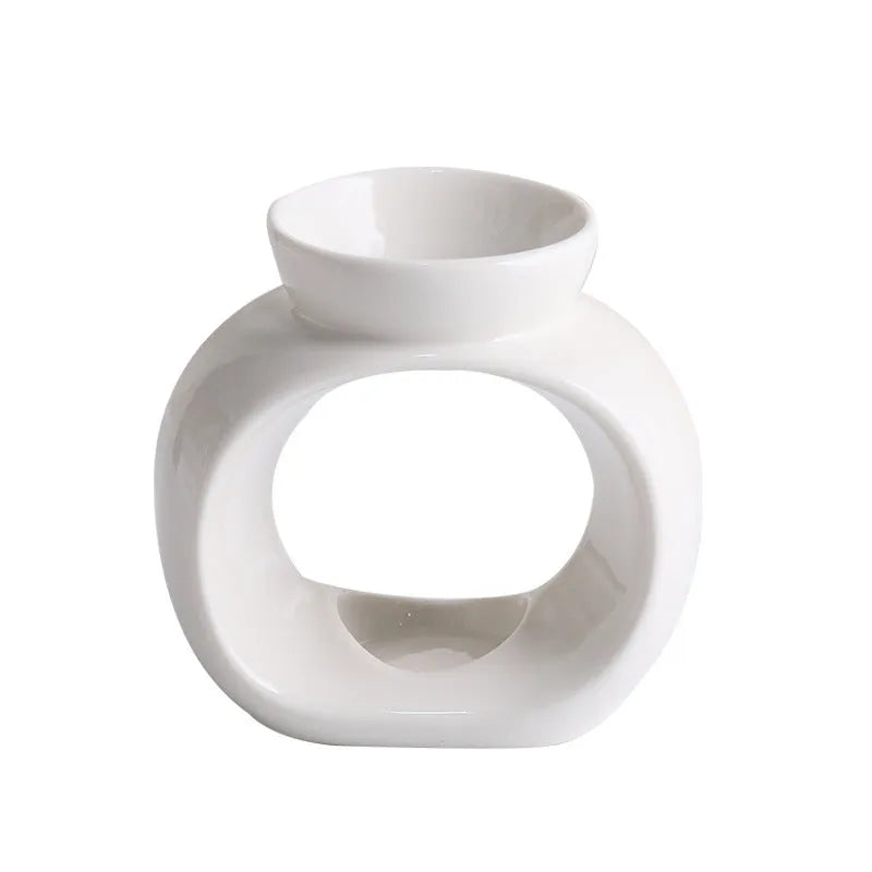White Nordic style ceramic aromatherapy stove ornament on a table.