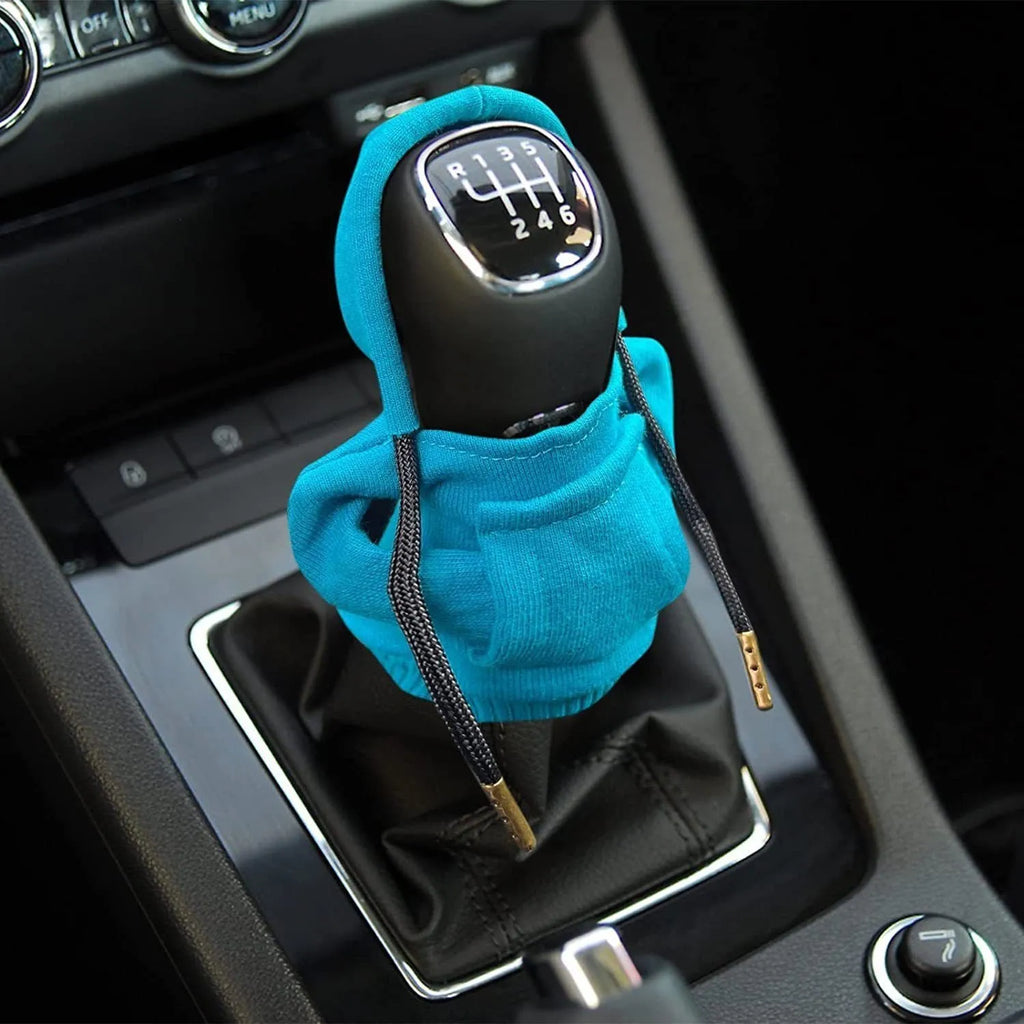 Blue cloth gear shift knob cover on a car's manual transmission lever.