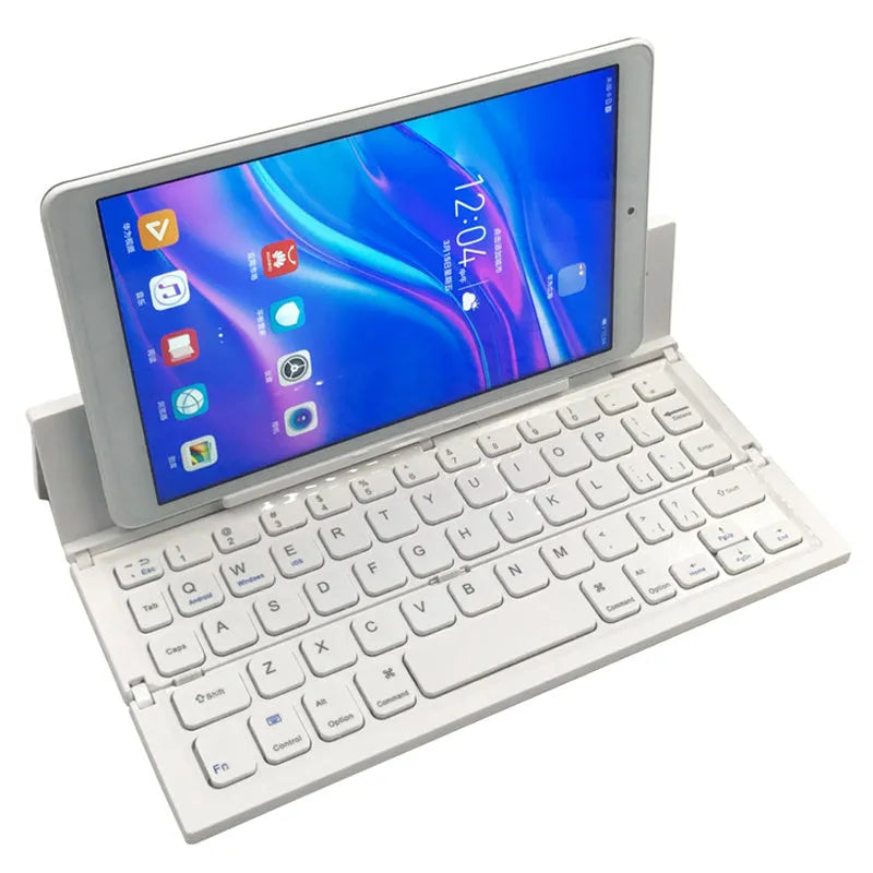 Black folding Bluetooth wireless keyboard next to tablet showing compact portable design