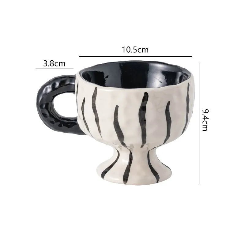 Hand-pinched irregular shaped ceramic mug in a solid colour, shown from the side.